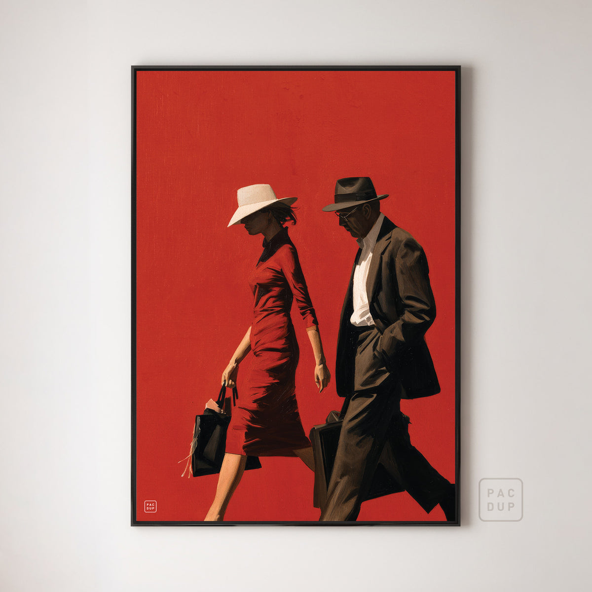 Art print of a woman in a red dress and a man in a dark suit walking against a red background, displayed in a black frame.