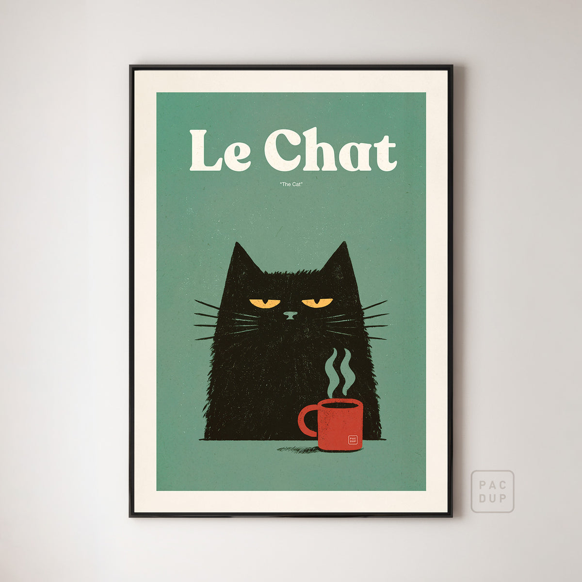 Le Chat art print of a black cat beside a steaming red mug on a muted green background, displayed in a black frame.